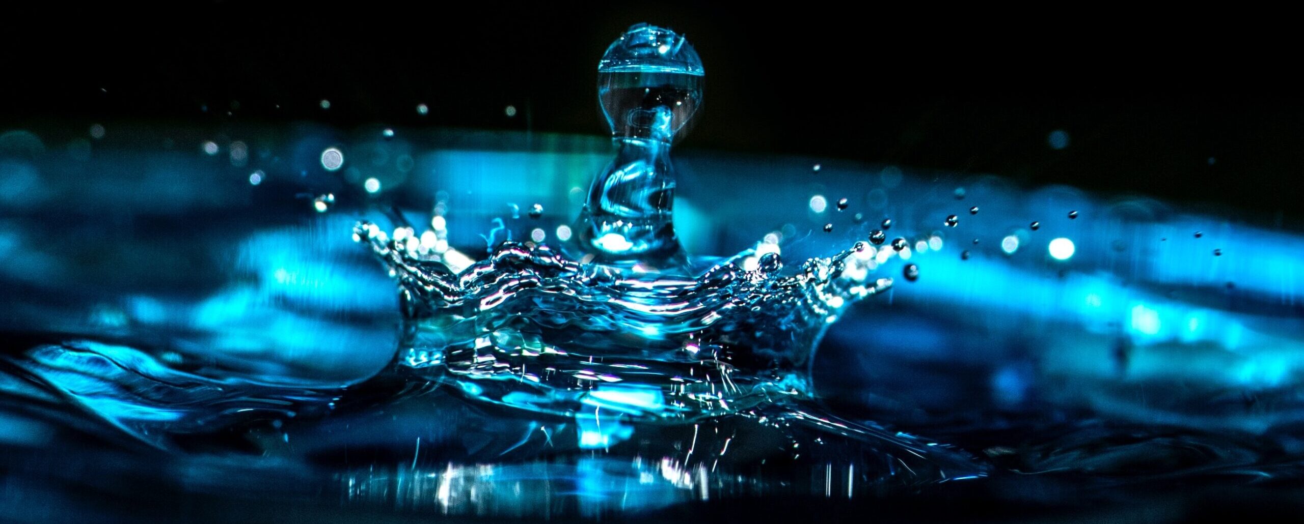 Close-up photo of the splash from a droplet falling into clear water. Like the ripple effect stretching out in all directions, the choices we make based on our digital literacies affect all aspects of our modern lives.