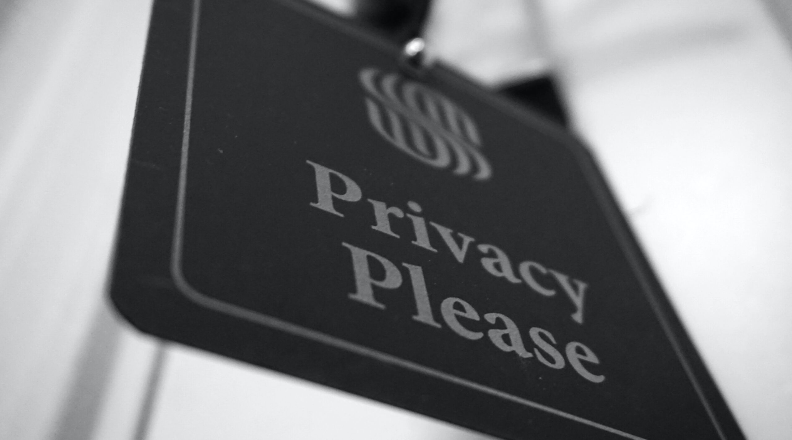 A bottom-up view of a black sign with the text "Privacy Please"